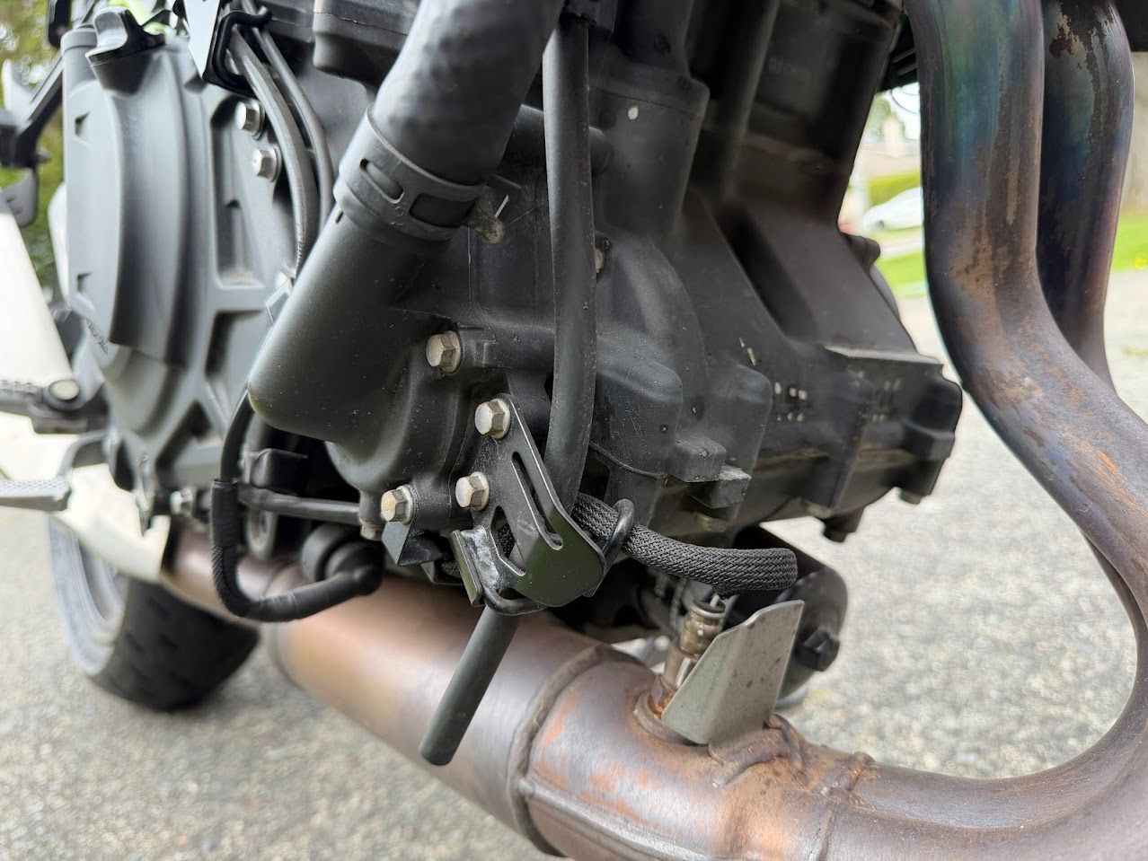 Motorcycle engine, hoses and exhaust inspected before a longer ride